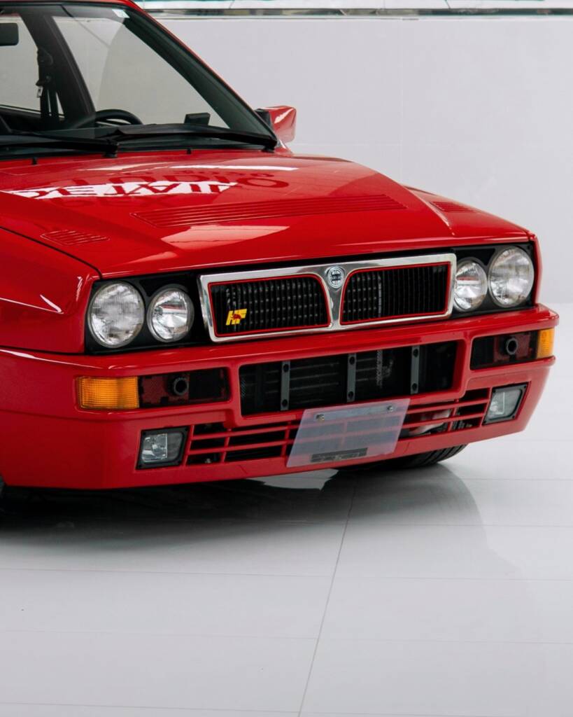 Quad headlights and grille of the red Lancia Delta Integrale before the colour change at Apex Detail Studio Dubai
