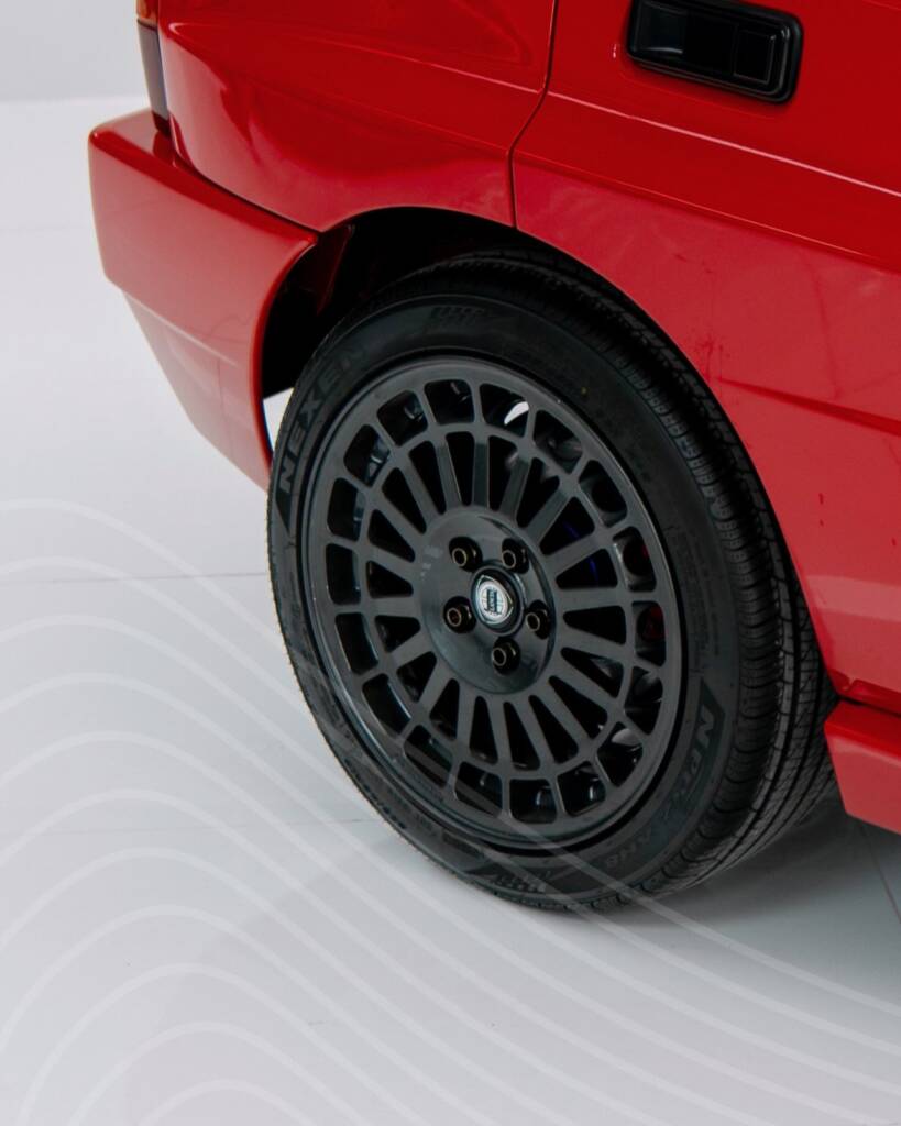 Red rear wheel arch and wheel of the Lancia Delta Integrale before the respray at Apex Detail Studio Dubai