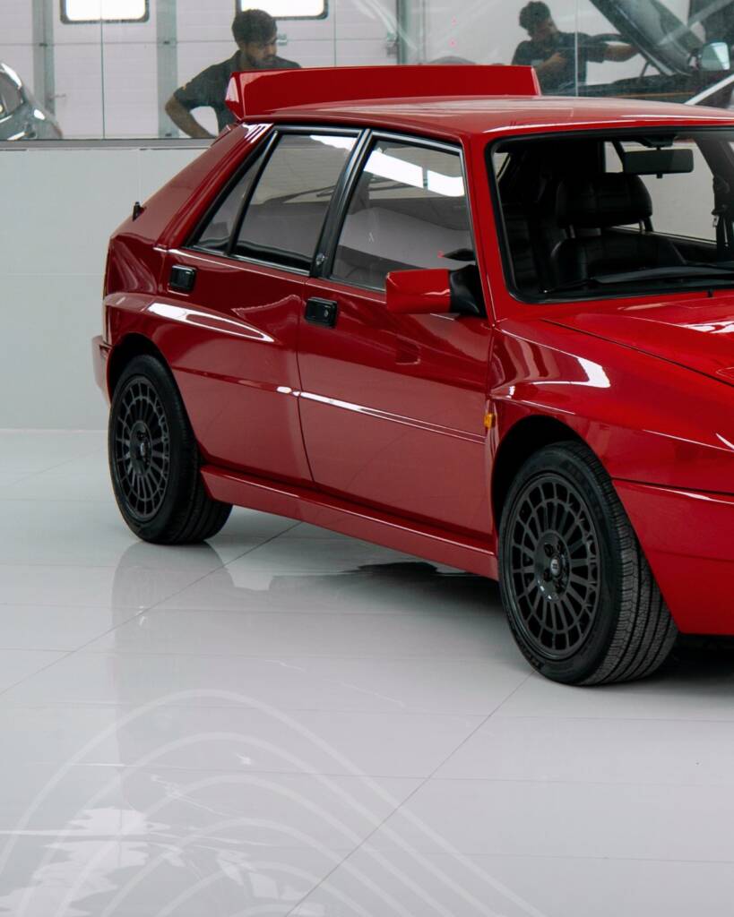 Side profile of the red Lancia Delta Integrale before full body paint at Apex Detail Studio Dubai