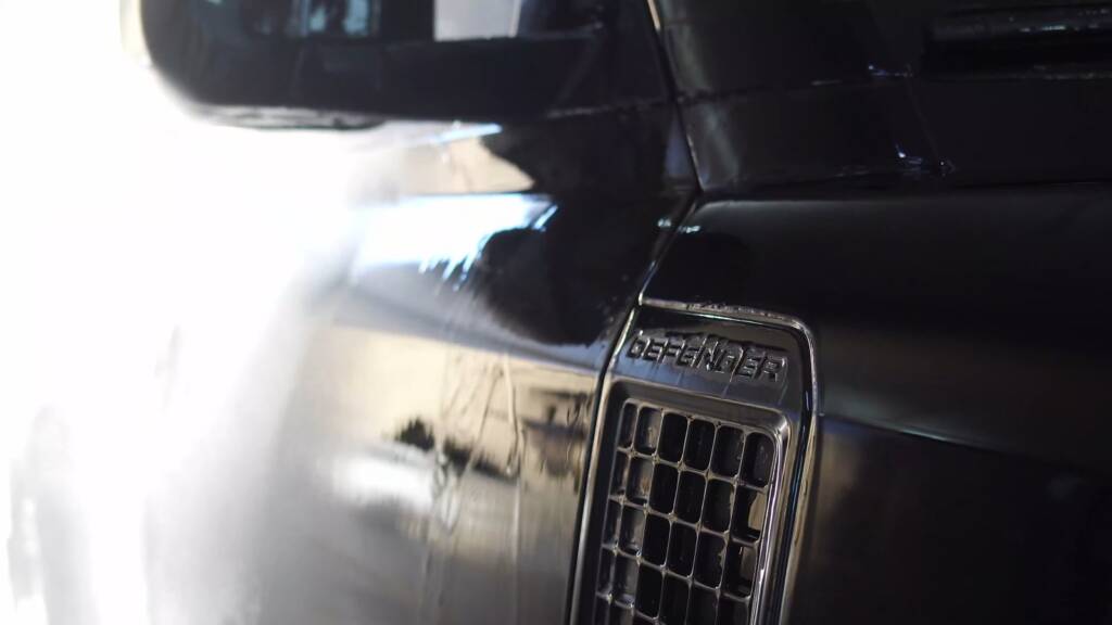 Rinsing the grille of a Land Rover Defender 130