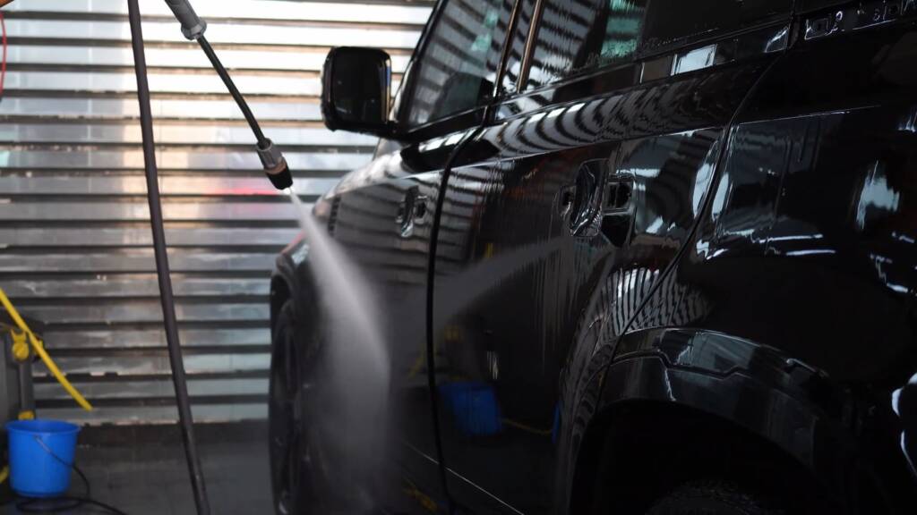 Rinsing a black Land Rover Defender 130