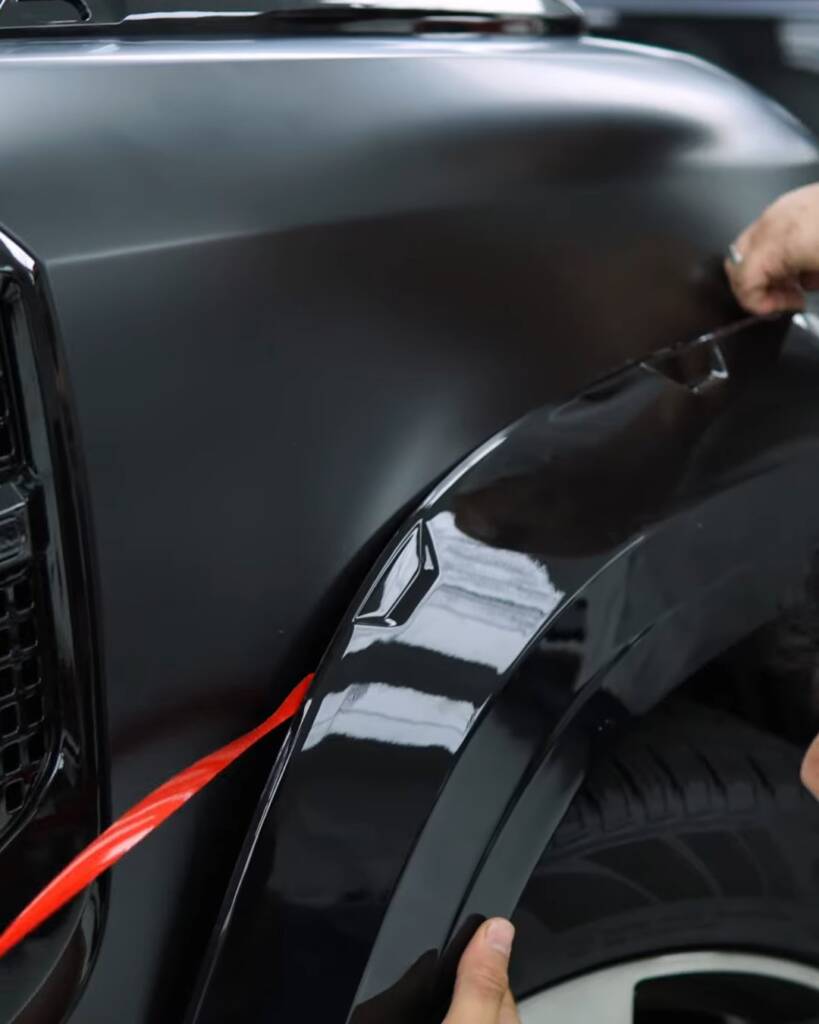 Arch flare being fitted on a Defender during a body kit upgrade at Apex Dubai