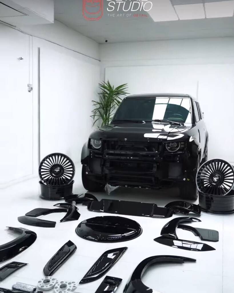 Defender body kit parts laid out next to a 2026 Land Rover Defender in Dubai