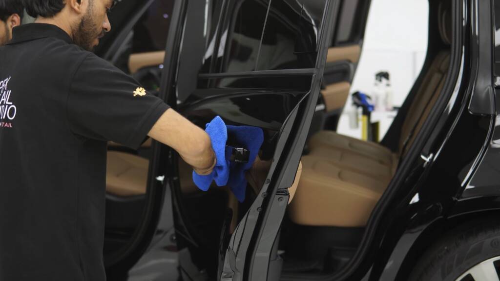 Cleaning the door shuts of a Land Rover Defender after PPF, Dubai