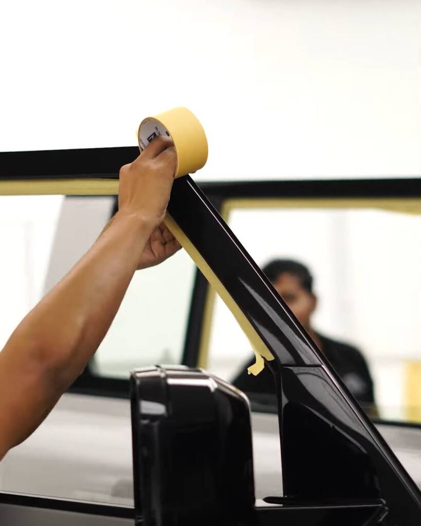 Masking tape applied to the A-pillar of a Defender before tint, Dubai
