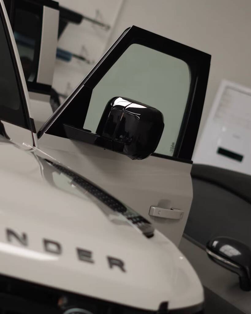 Bonnet and tinted front door of a white 2026 Land Rover Defender, Dubai