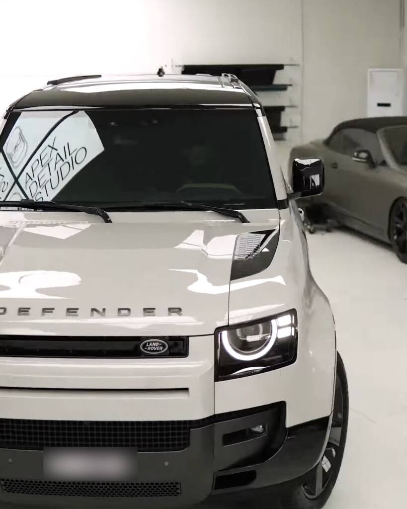White 2026 Land Rover Defender with black roof at Apex Detail Studio Dubai