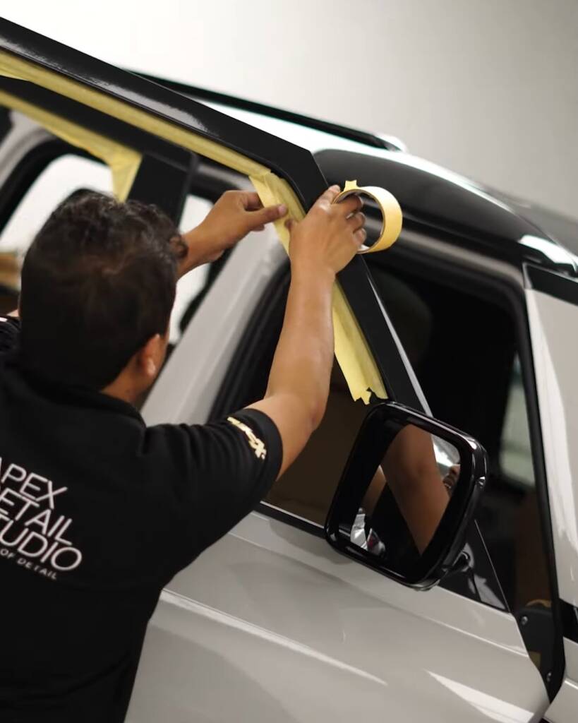 Front door of a 2026 Defender masked before window tint, Apex Dubai