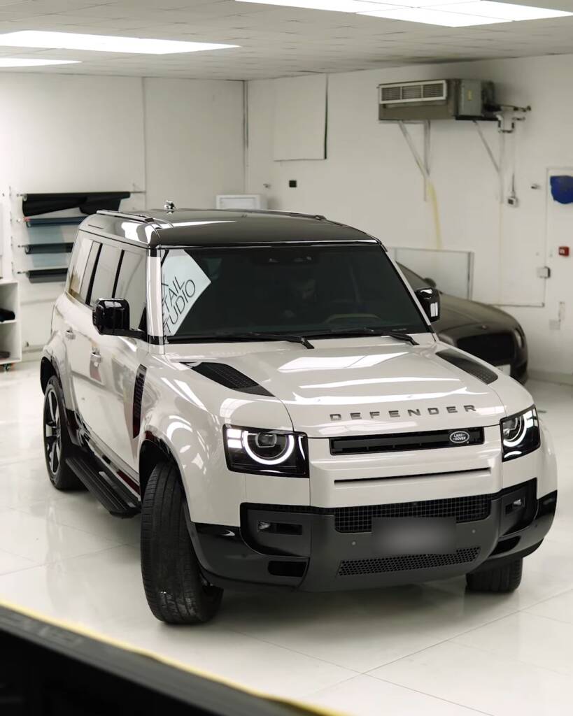 White 2026 Land Rover Defender with full window tint in the Apex Detail Studio showroom