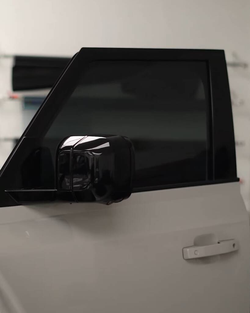 Close up of tinted door glass on a white 2026 Land Rover Defender, Dubai