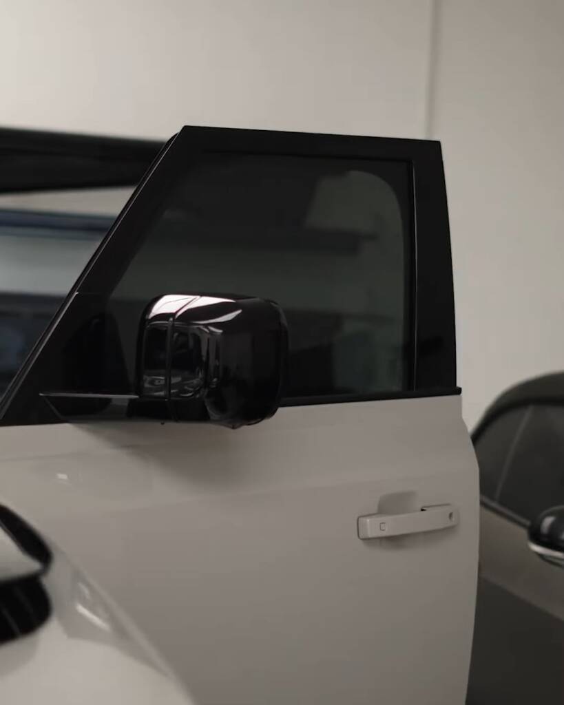 Tinted front door glass and mirror on a 2026 Land Rover Defender at Apex Dubai