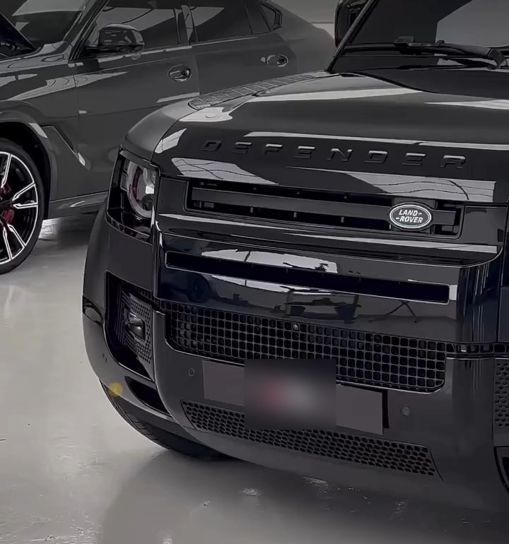Front grille and bumper of a blacked-out Land Rover Defender at Apex Detail Studio Dubai