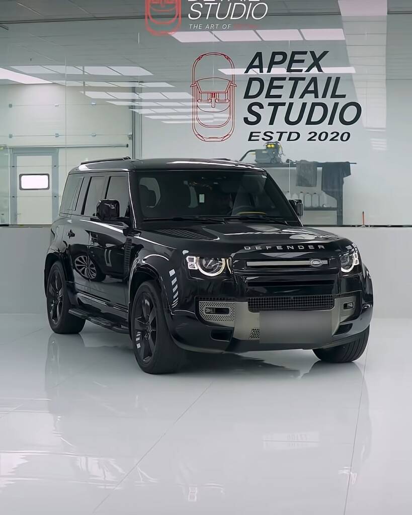 Black Land Rover Defender in the Apex Detail Studio showroom before Sedona Red colour PPF