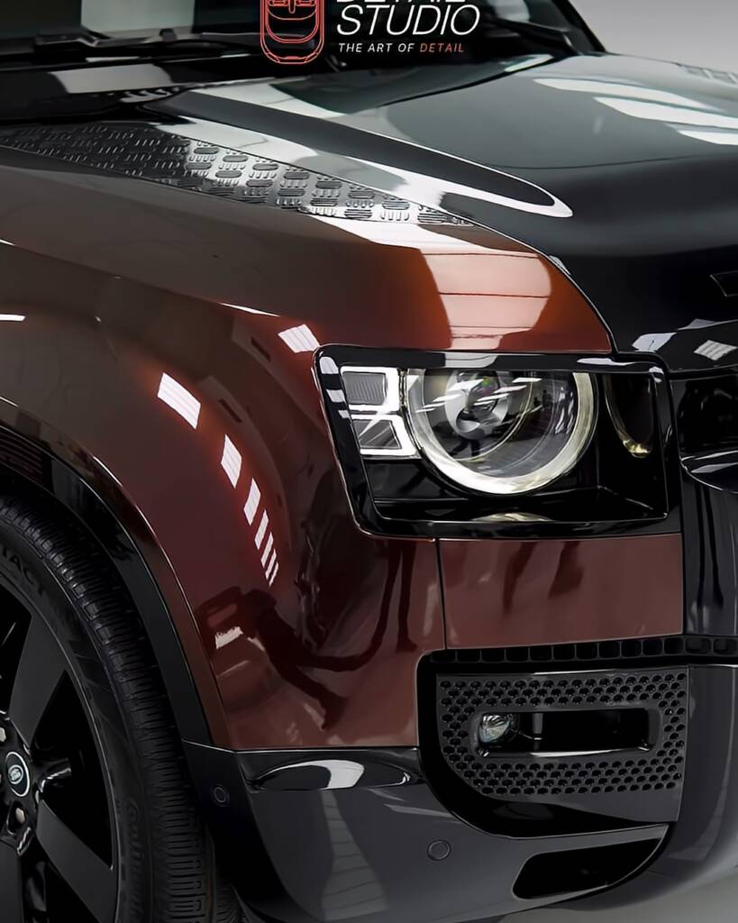 Front wing and headlight of a Land Rover Defender in Sedona Red colour PPF, Apex Dubai