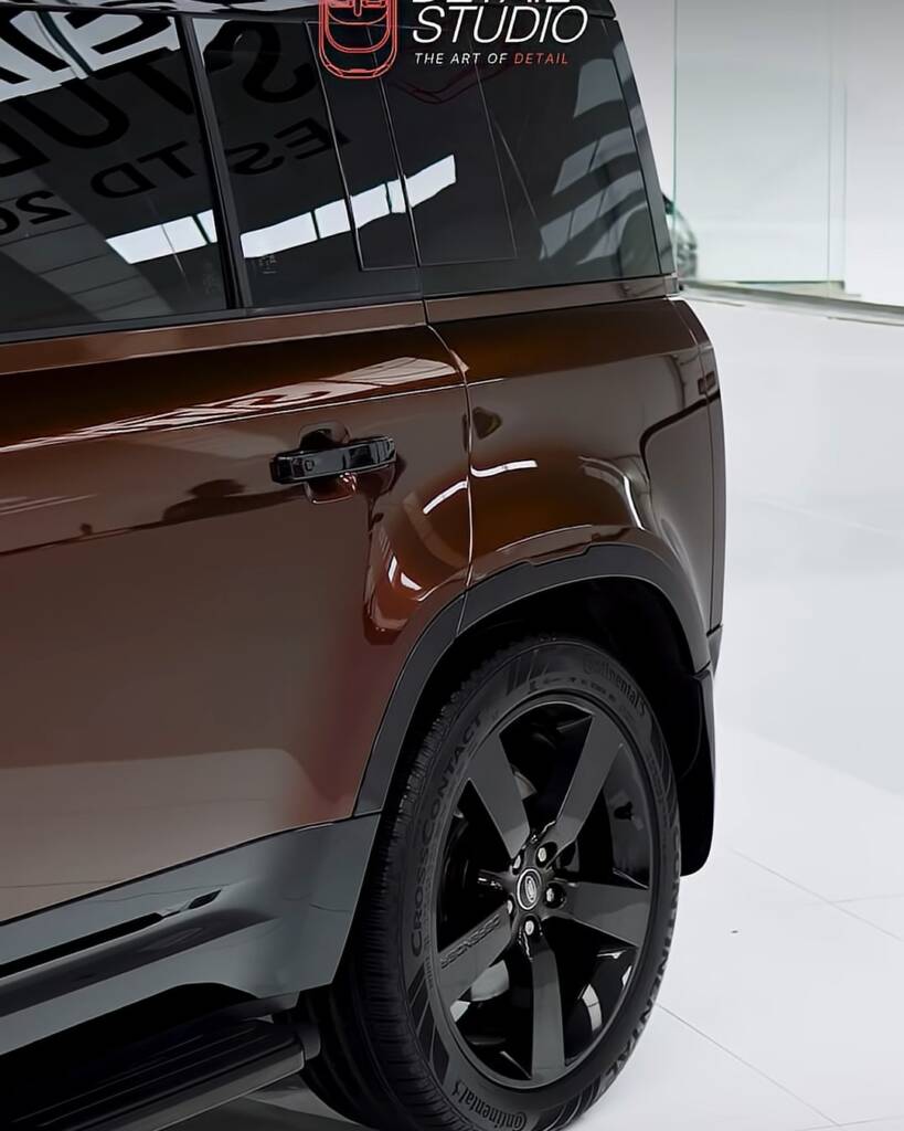 Rear quarter and wheel of a Land Rover Defender in Sedona Red colour PPF, Dubai