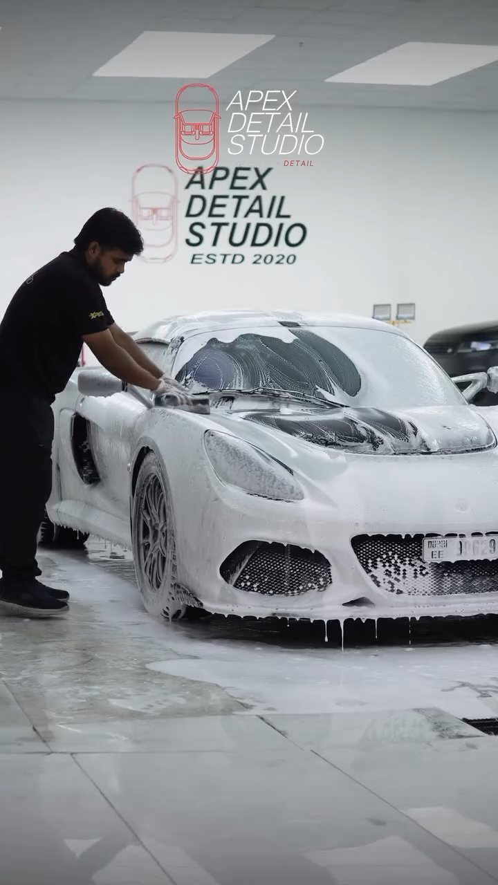 Apex detailer hand washing the silver Lotus Exige 410 Sport