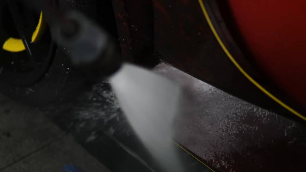 Rinsing a Mansory Pugnator wheel arch before PPF