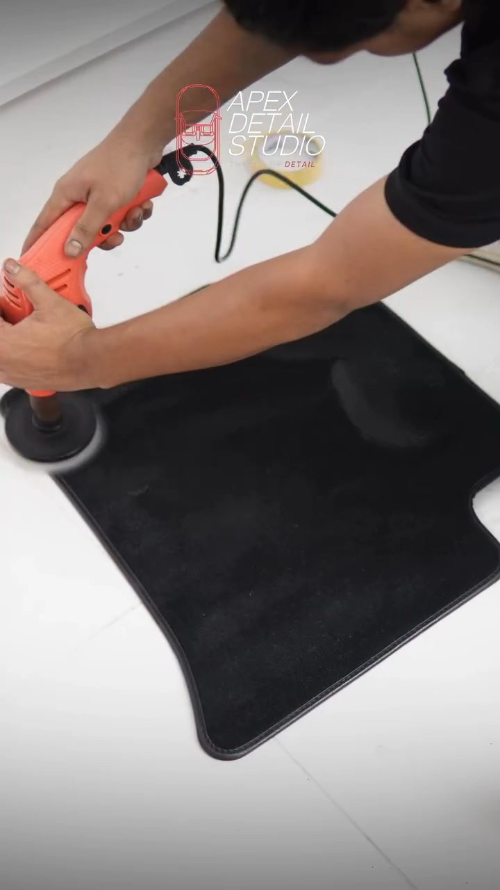 Floor mat being machine cleaned for the Maserati Grecale at Apex Detail Studio