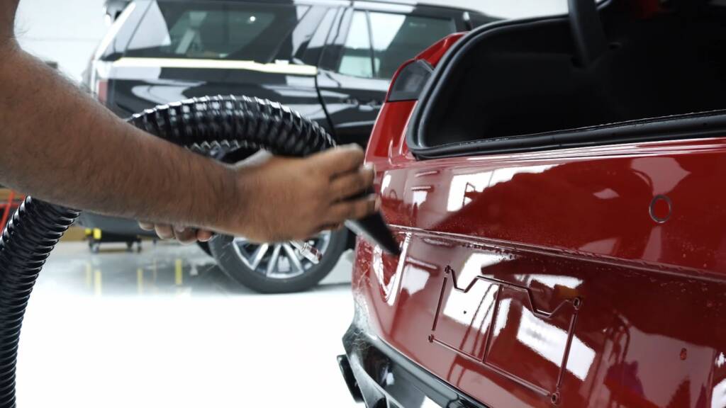 Fitting premium PPF to a red 2024 Mercedes-AMG CLA boot lid in Dubai