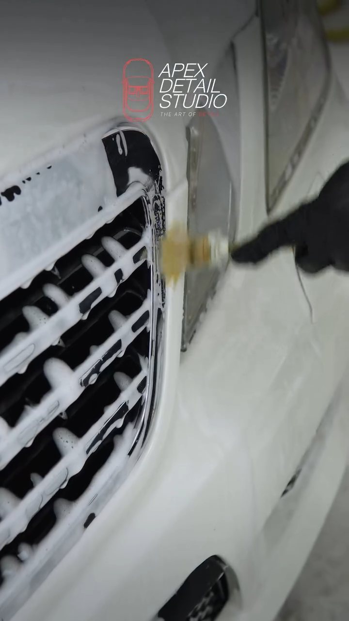 Detailing brush cleaning the Mercedes-AMG E63 front grille in Dubai