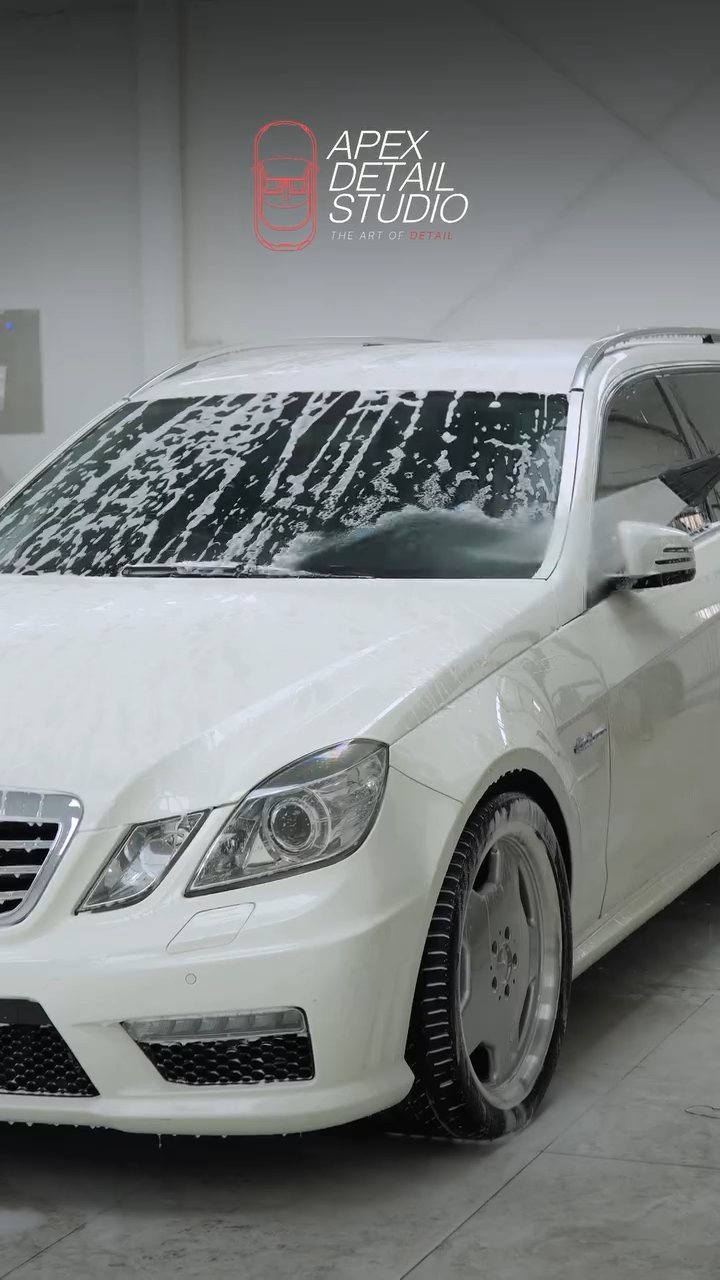 White Mercedes-AMG E63 estate covered in snow foam at Apex Detail Studio Dubai