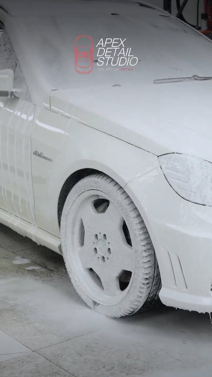 Mercedes-AMG E63 wheel and wing under snow foam at Apex Detail Studio