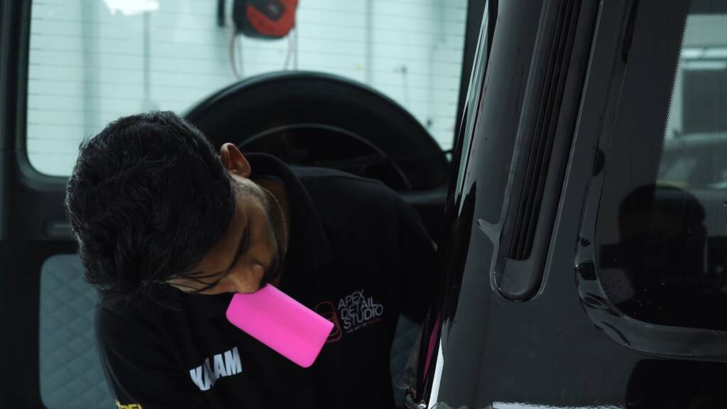 Squeegee on PPF on a Mercedes-AMG G63 rear side panel