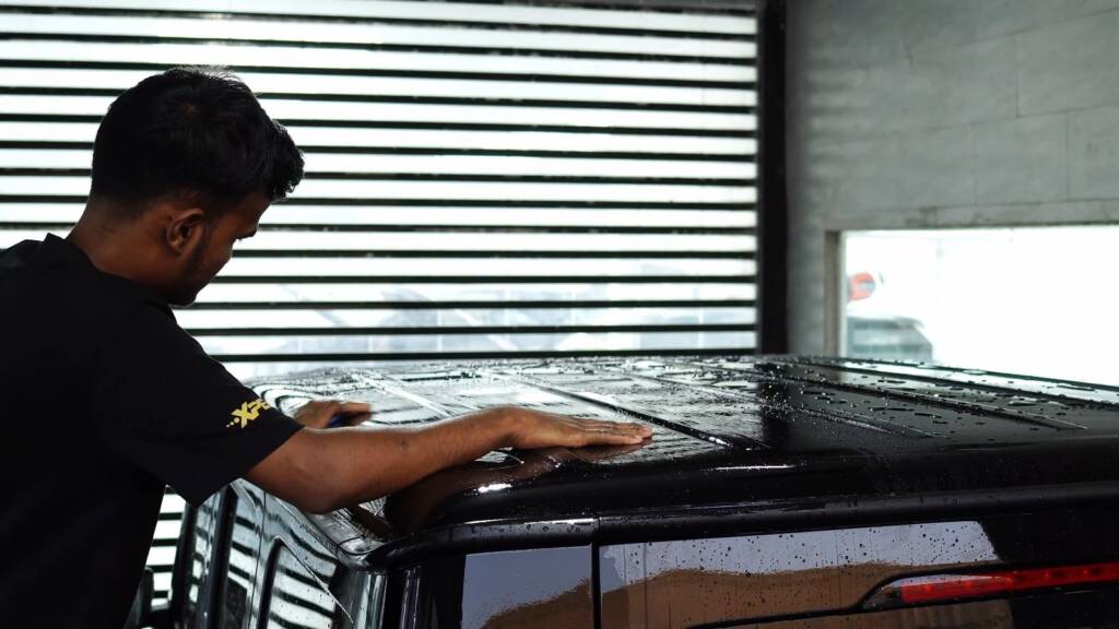 Washing the roof of a black Mercedes-AMG G63 before PPF