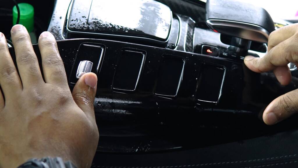 Installer squeegeeing interior PPF on an AMG GT Black Series console