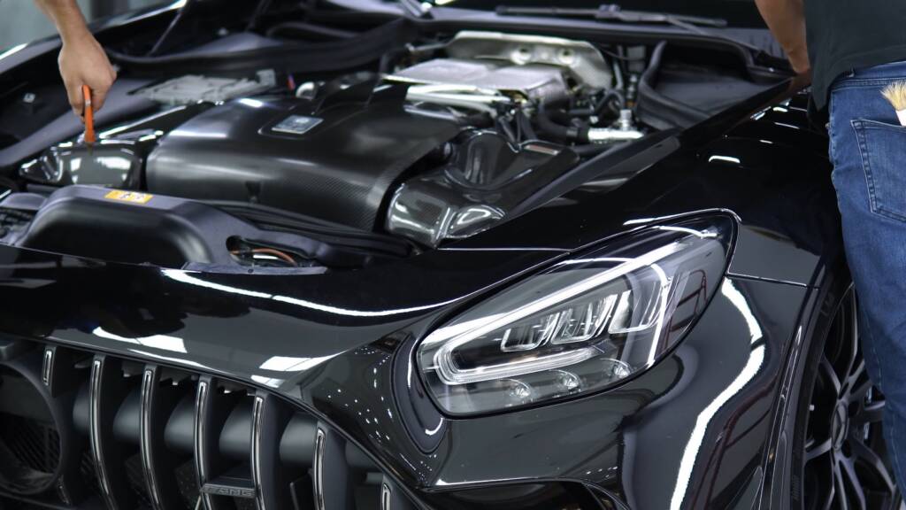 Detailer cleaning the engine cover of an AMG GT Black Series