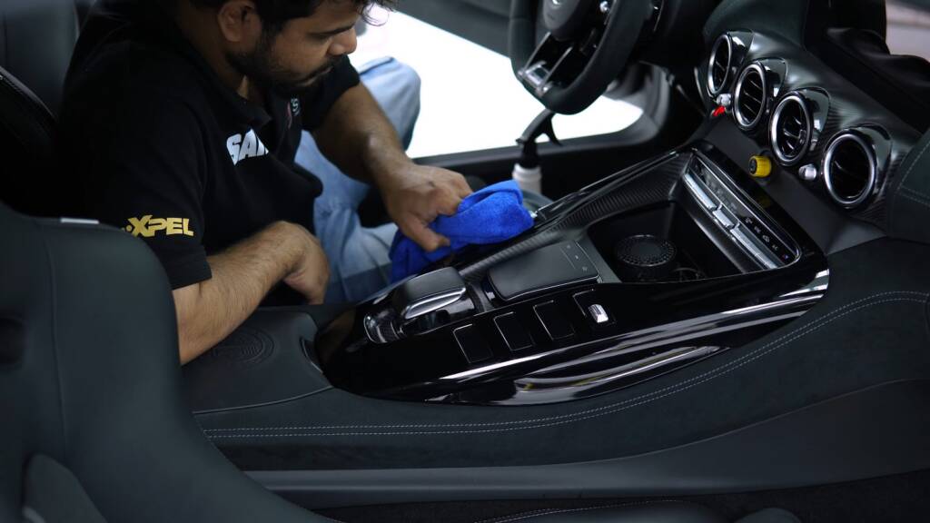 Detailer working on the interior of an AMG GT Black Series