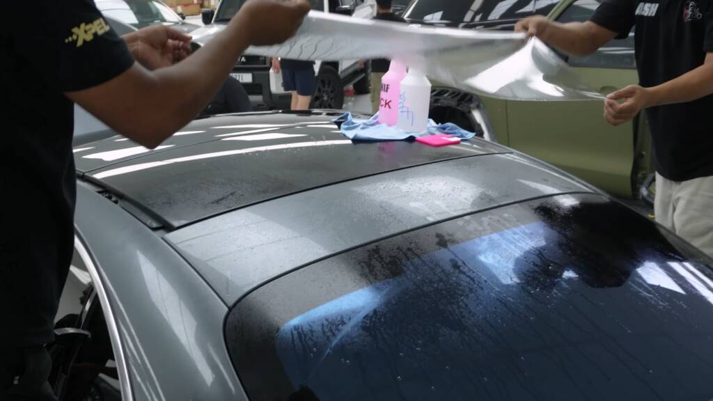 Paint protection film being laid on the boot lid of a Mercedes-Benz S500