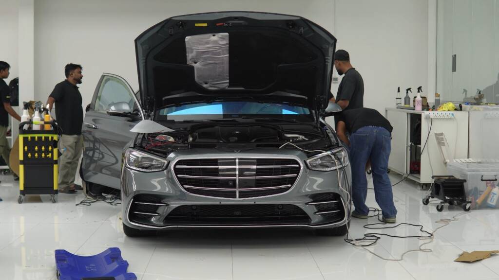 Front of a grey Mercedes S500 with the bonnet open during PPF installation at Apex