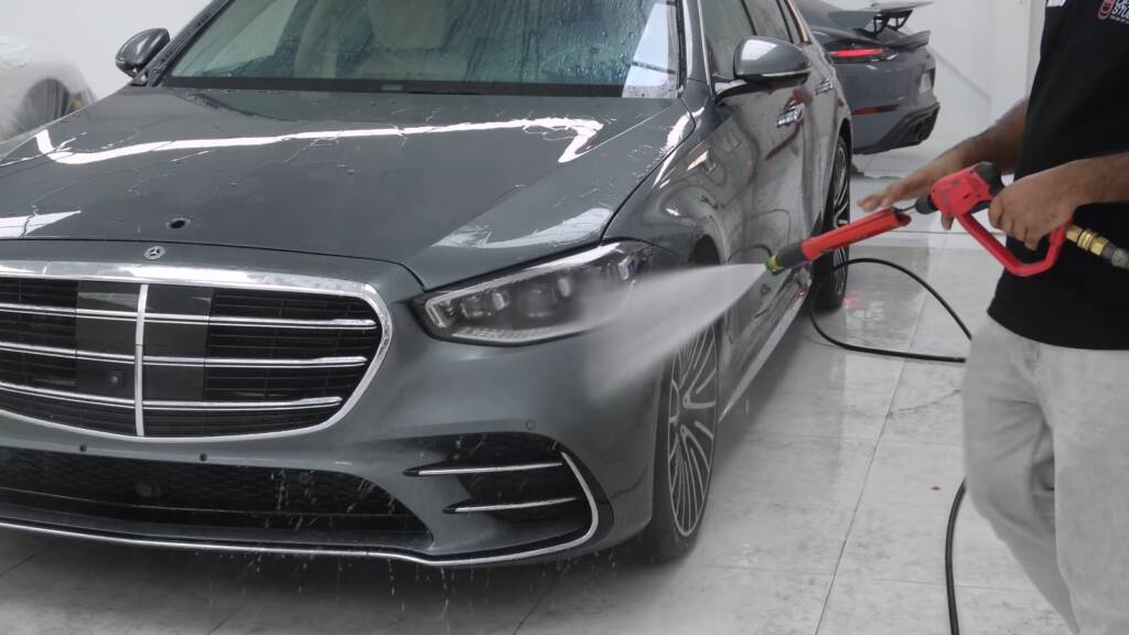 Apex installer working on the front of a grey Mercedes-Benz S500 during PPF preparation in Dubai