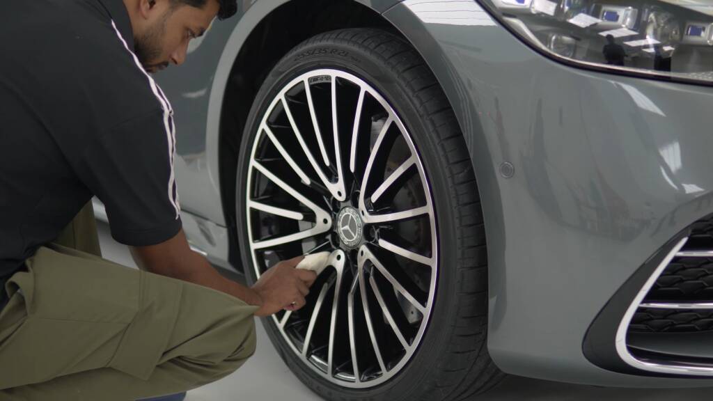 Detailer cleaning the alloy wheel of a Mercedes S500 at Apex Detail Studio