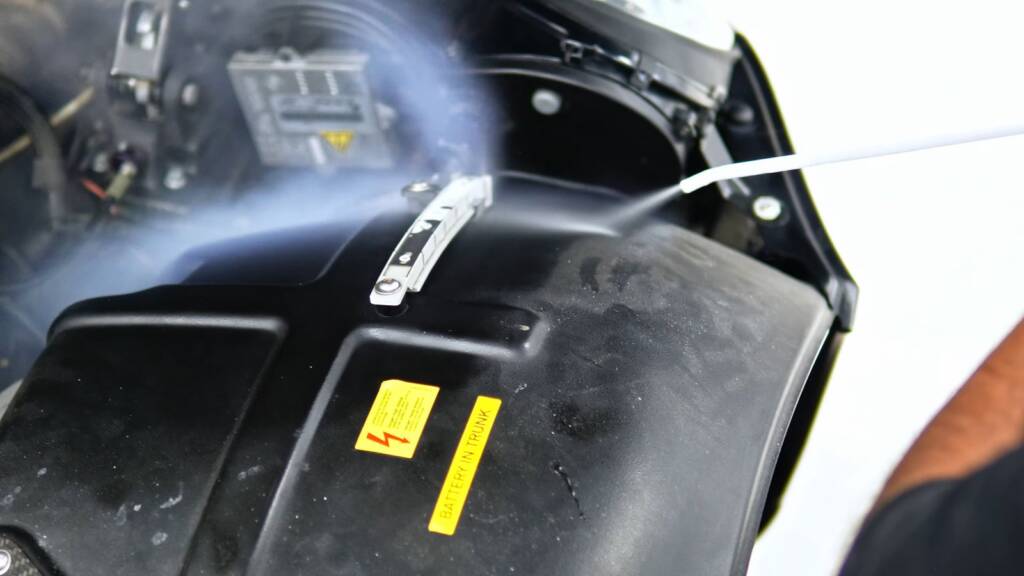 Dry ice lifting grime from engine bay plastics on a black Mercedes SLR McLaren in Dubai