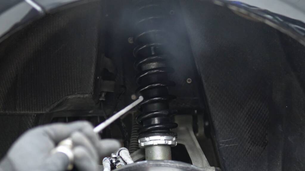 Dry ice cleaning the coilover inside the wheel arch of a Mercedes-Benz SLR McLaren at Apex Detail Studio