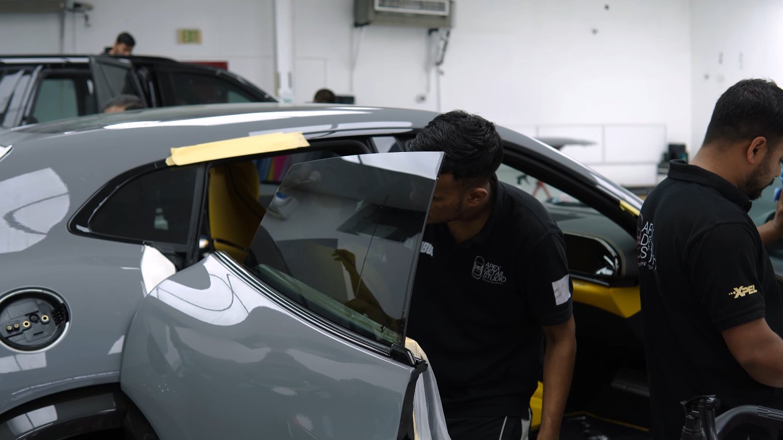 Apex team finishing Nardo Grey colour PPF on a Ferrari Purosangue in Dubai