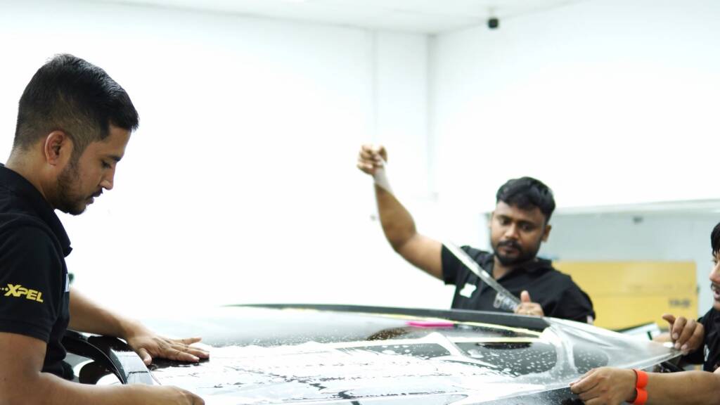 Installers laying premium PPF on a Nissan Patrol Nismo bonnet