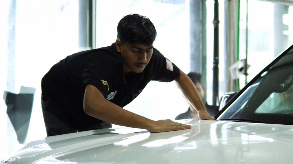 Hand washing a white 2025 Nissan Patrol Nismo before premium PPF