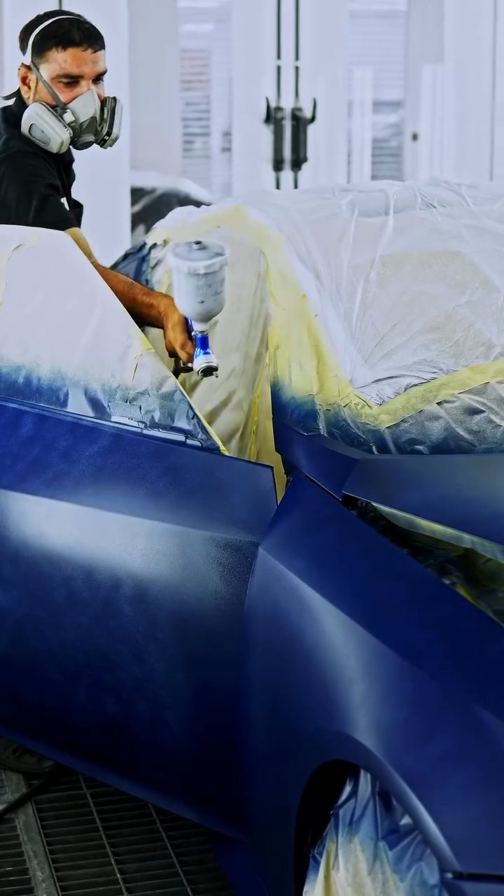 Painter spraying the Nissan Z with peelable paint at Apex Detail Studio