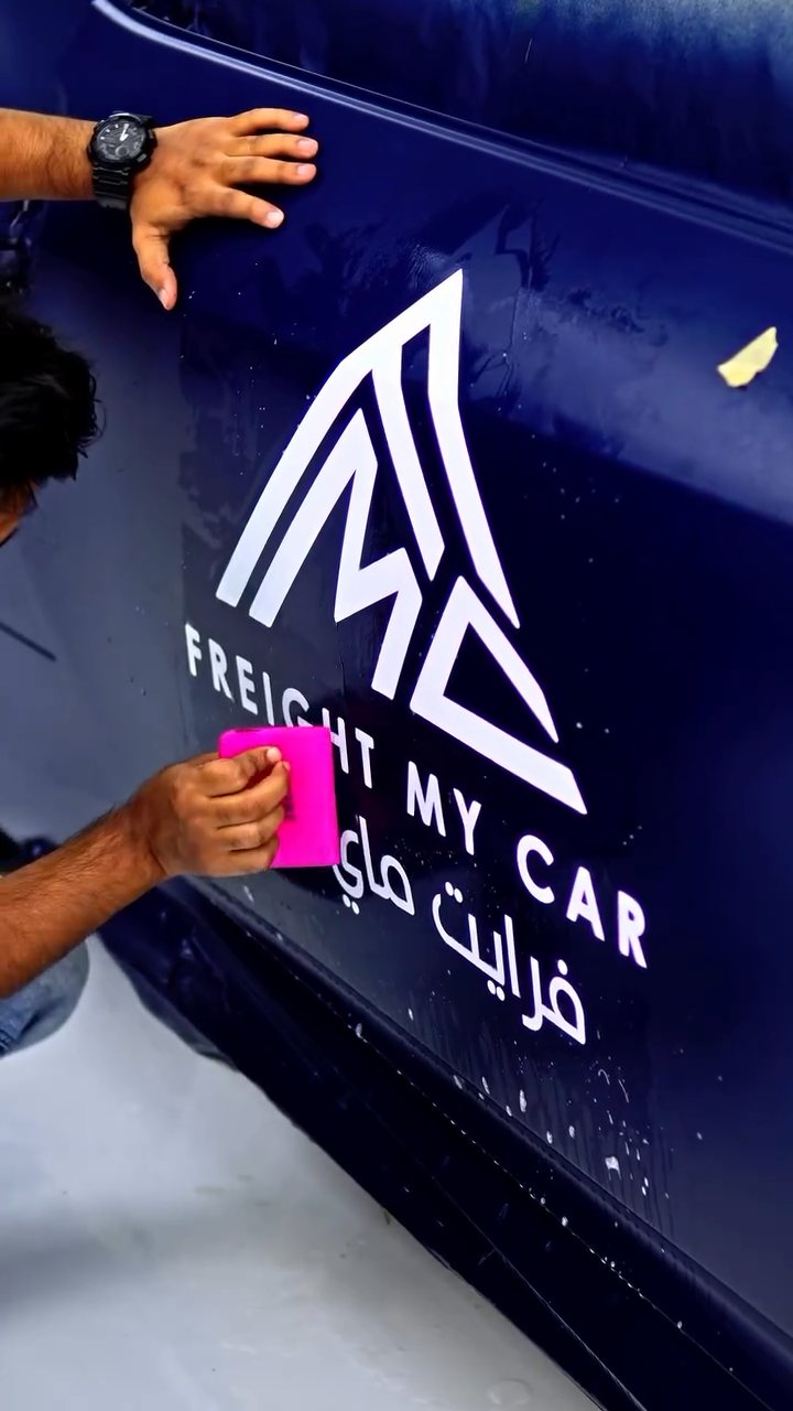 Door logo decal being finished on the blue Nissan Z at Apex Detail Studio Dubai