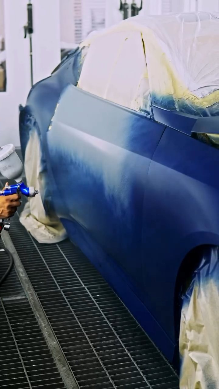 Nissan Z masked in the spray booth with blue peelable paint on the side in Dubai