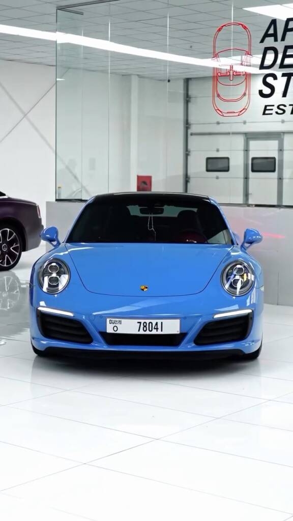 Front view of the Porsche 911 Carrera in blue colour change PPF with window tint, Apex Detail Studio Dubai