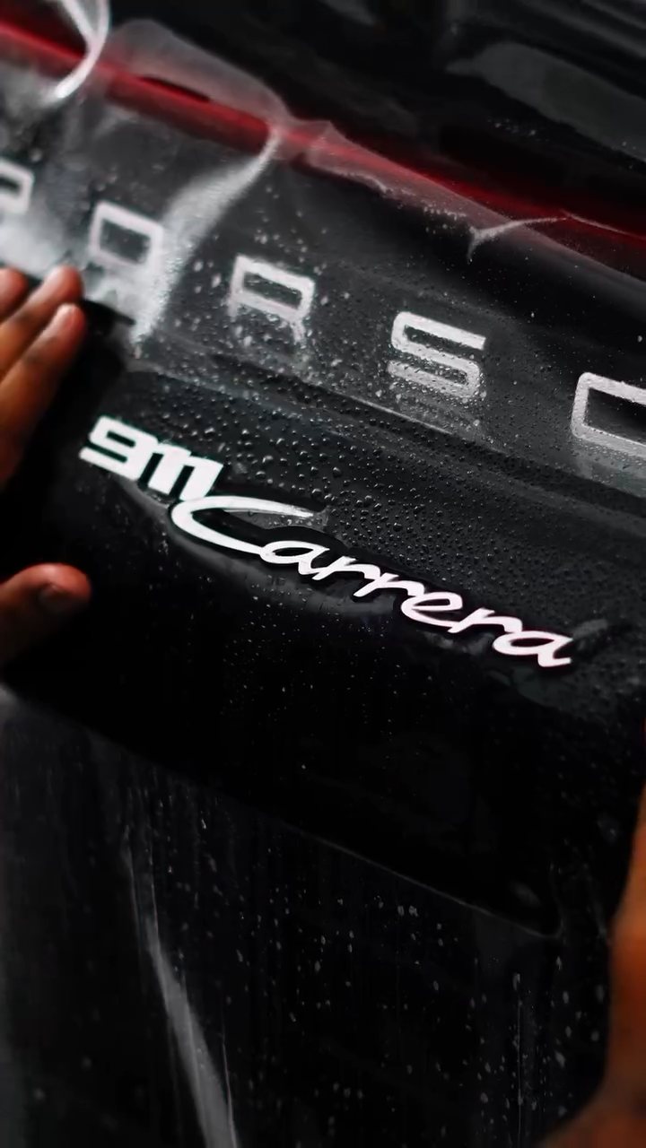 911 Carrera badge on the engine lid during PPF at Apex Detail Studio