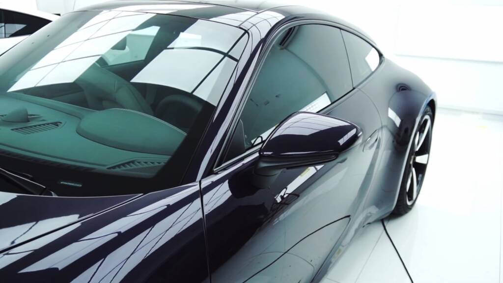 Gloss side profile of a Viola Metallic Porsche 911 Carrera under clear PPF in Dubai
