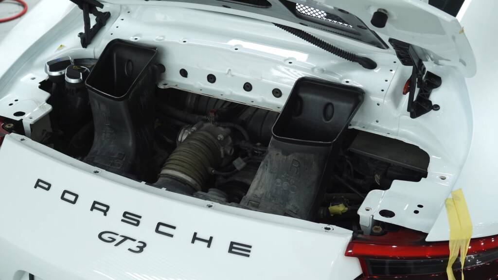 Porsche 911 GT3 engine bay before dry ice cleaning in Dubai
