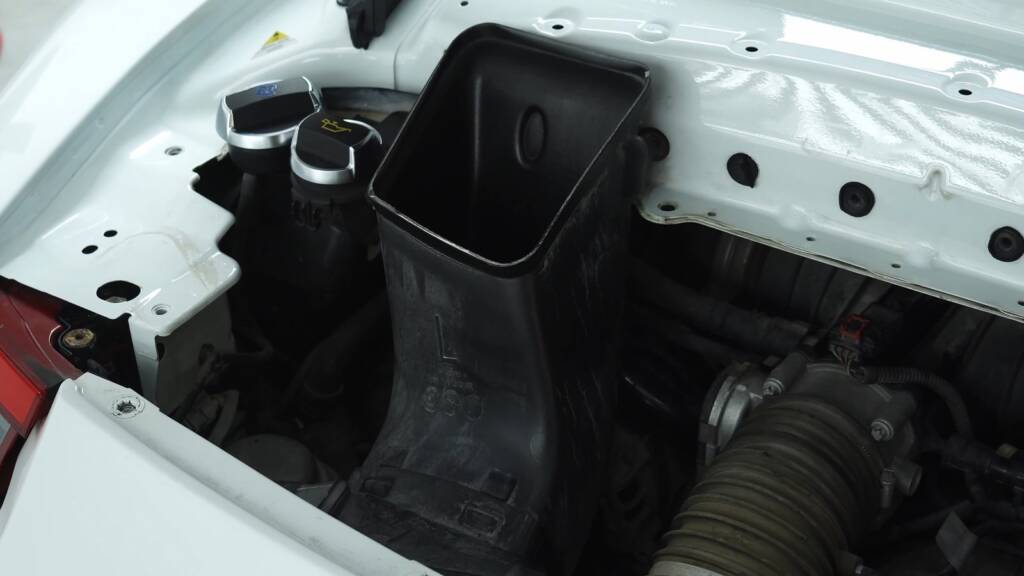 Dirty intake area on a Porsche 911 GT3 engine bay