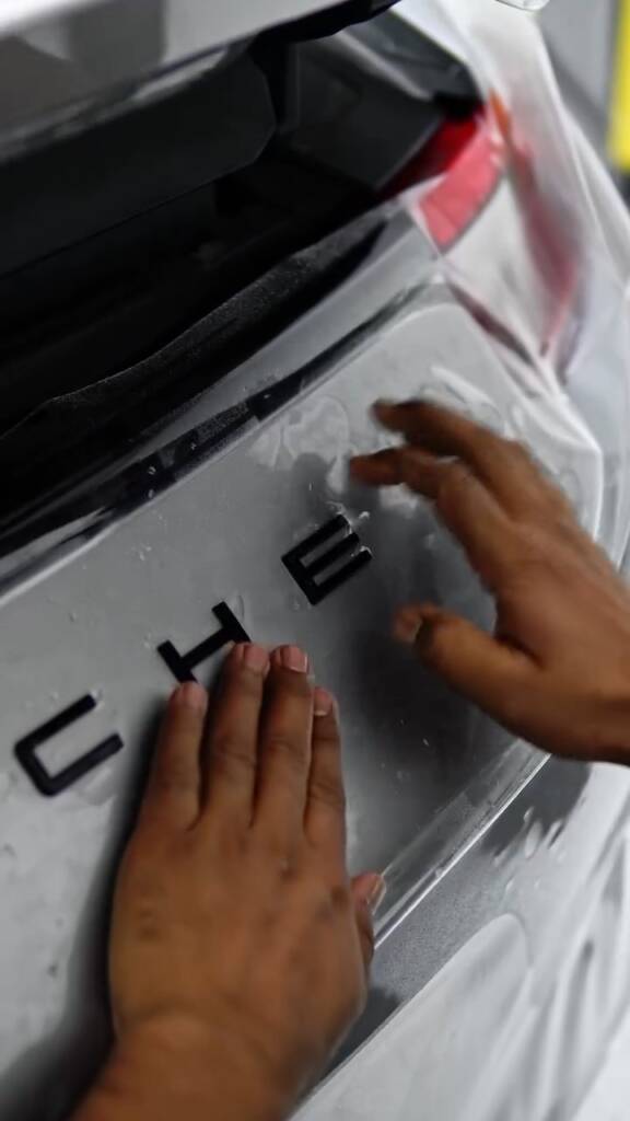 PPF pressed down around the PORSCHE lettering on a 911 engine lid at Apex Detail Studio