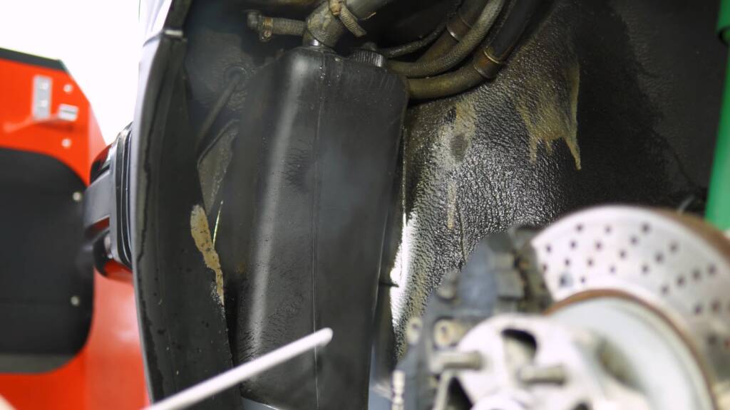 Wheel arch liner of a Porsche 930 Turbo being cleaned with dry ice